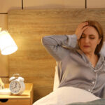 Woman experiencing sleep problems during menopause while lying awake at night